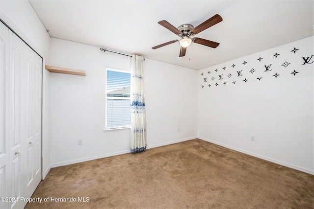 interior space with ceiling fan and carpet