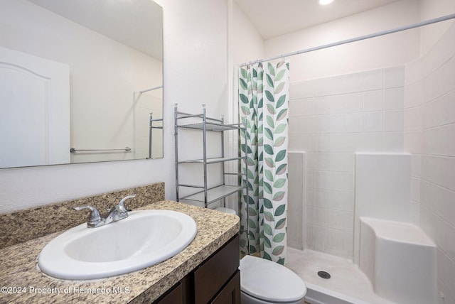 bathroom with a shower with curtain, vanity, and toilet