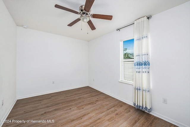 unfurnished room featuring hardwood / wood-style floors and ceiling fan