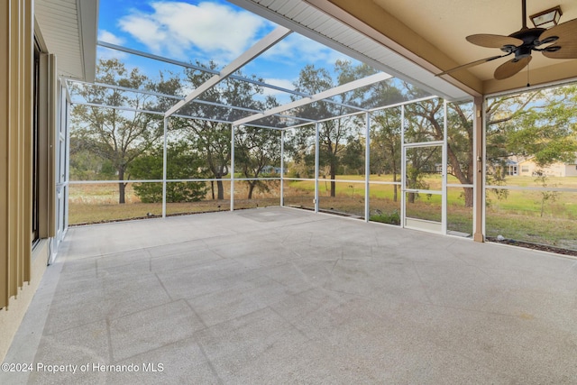 unfurnished sunroom with ceiling fan and a healthy amount of sunlight