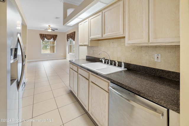 kitchen with sink, ceiling fan, light tile patterned floors, appliances with stainless steel finishes, and tasteful backsplash