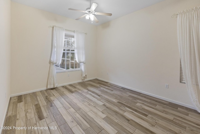 empty room with light wood-type flooring and ceiling fan