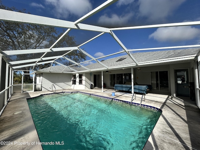 view of swimming pool with a patio and a lanai