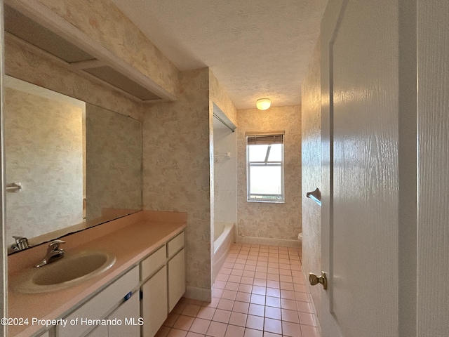 full bathroom with vanity, bathtub / shower combination, tile patterned flooring, toilet, and a textured ceiling