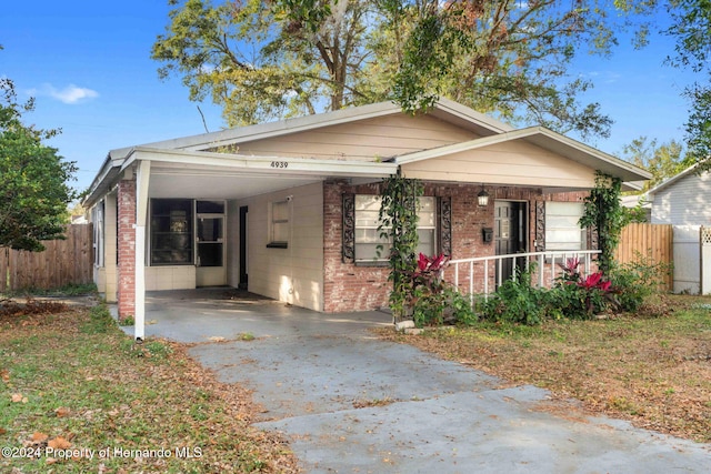 bungalow-style house with a porch and a carport