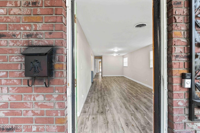 corridor with wood-type flooring