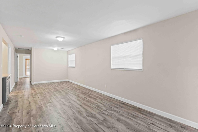 unfurnished room with light hardwood / wood-style floors