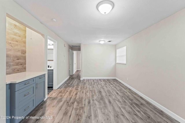 interior space with wood walls and light wood-type flooring