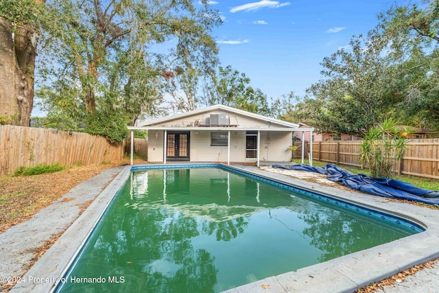 view of swimming pool featuring french doors