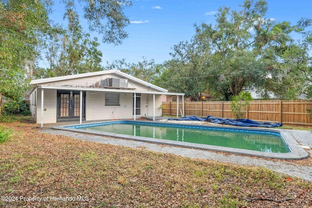 view of pool with french doors