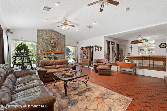 living room featuring a textured ceiling, a wealth of natural light, and ceiling fan