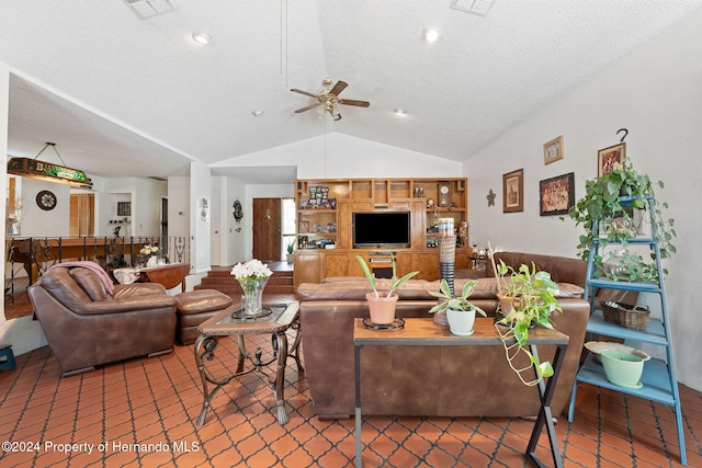 living room featuring tile patterned flooring, ceiling fan, lofted ceiling, and a textured ceiling