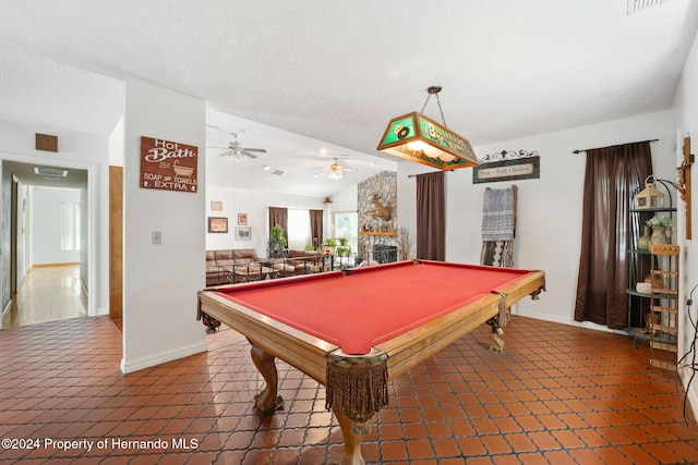 game room featuring ceiling fan, lofted ceiling, a fireplace, and pool table