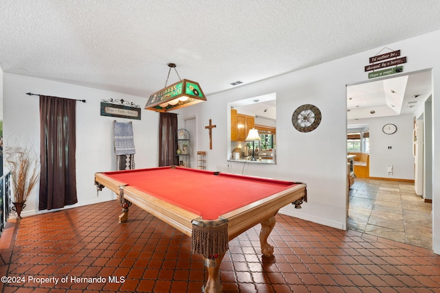 playroom featuring a textured ceiling and pool table