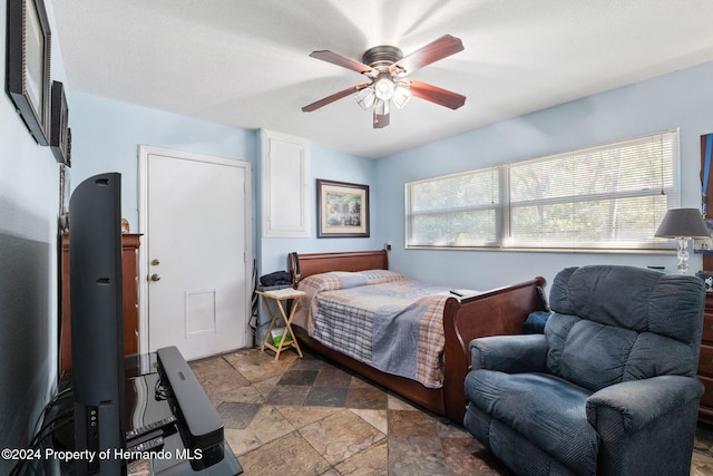 bedroom featuring multiple windows and ceiling fan