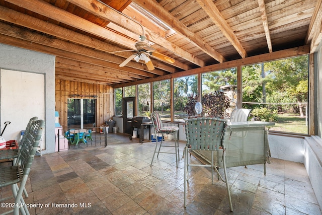 unfurnished sunroom with ceiling fan