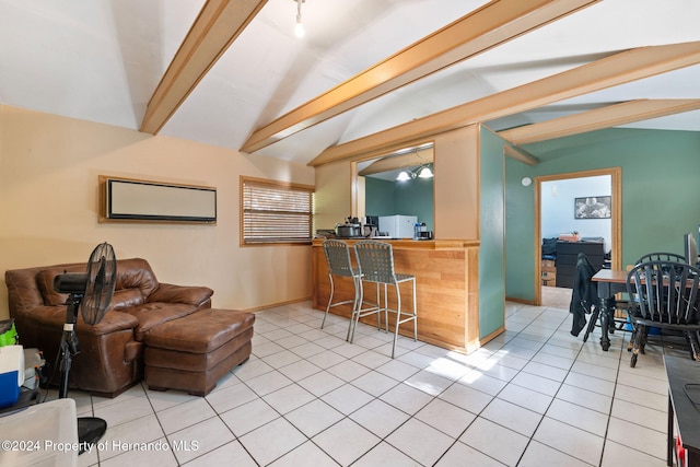 living room with light tile patterned floors and lofted ceiling with beams