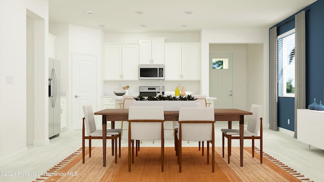 kitchen with white cabinets, light hardwood / wood-style floors, and stainless steel appliances