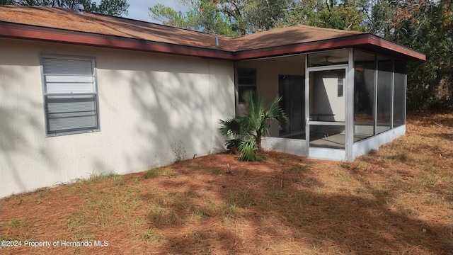 view of side of home with a sunroom