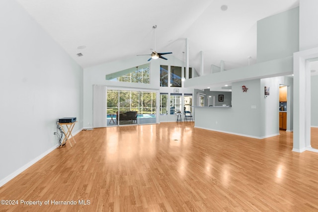 unfurnished living room with ceiling fan, light hardwood / wood-style flooring, and high vaulted ceiling