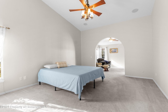 bedroom with ceiling fan, light colored carpet, and high vaulted ceiling