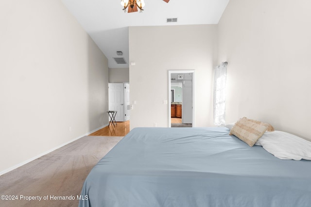 carpeted bedroom featuring vaulted ceiling