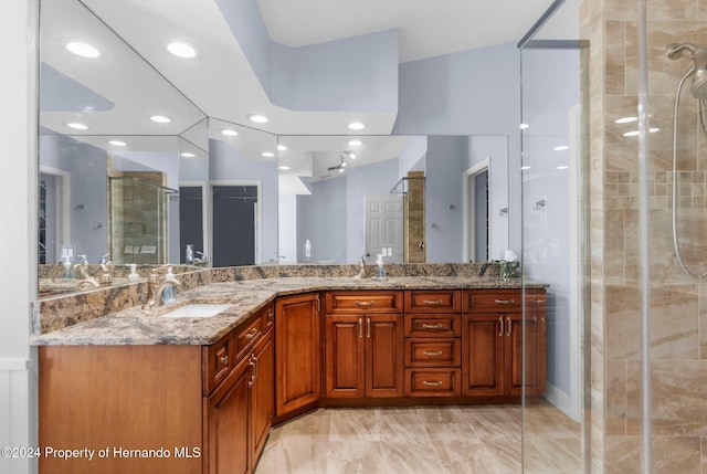 bathroom featuring vanity and a shower with door