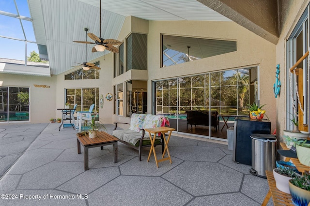 view of patio / terrace with ceiling fan and a lanai