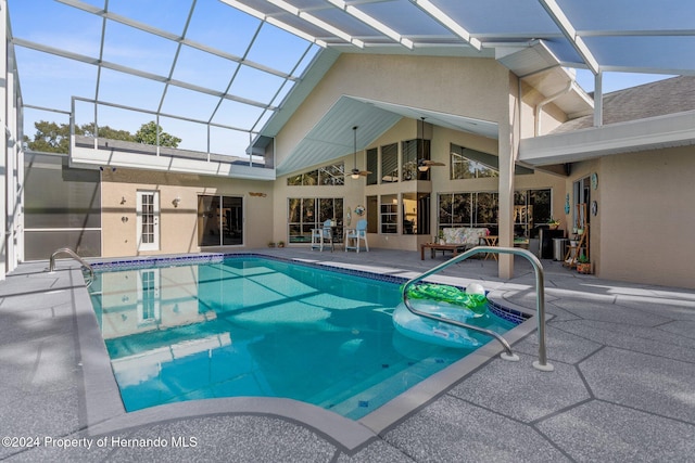 view of swimming pool with a patio area and a lanai