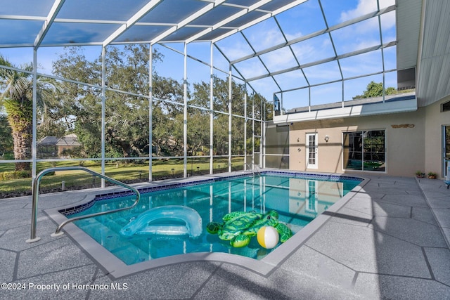 view of pool with a patio area and a lanai