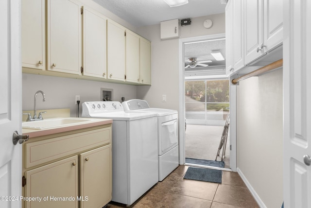 clothes washing area with cabinets, dark tile patterned flooring, sink, ceiling fan, and washer and dryer