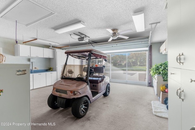 garage featuring a garage door opener and ceiling fan