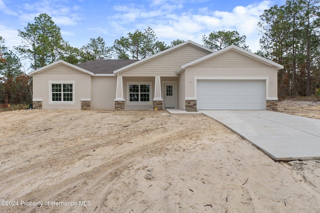 ranch-style house with covered porch and a garage