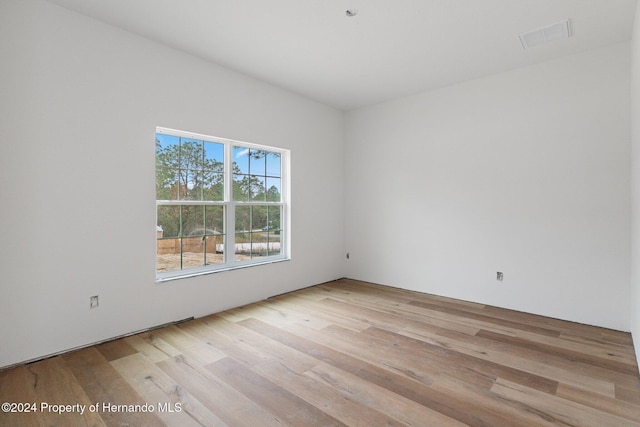 empty room with light hardwood / wood-style flooring