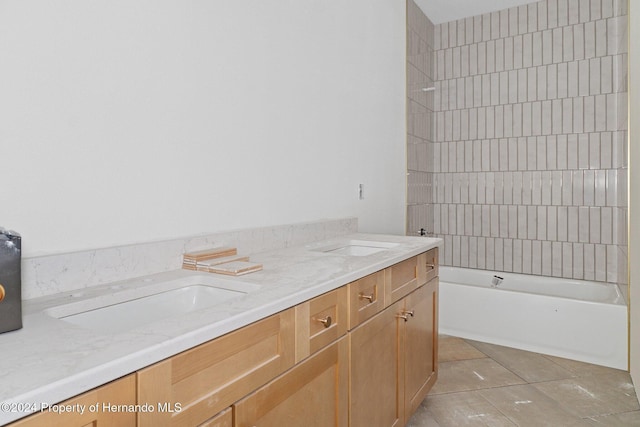 bathroom with vanity, tile patterned floors, and tiled shower / bath