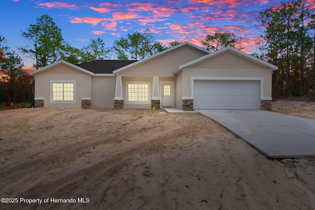 ranch-style home featuring stone siding, roof with shingles, concrete driveway, and an attached garage