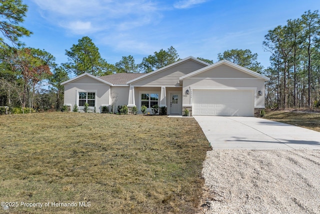 ranch-style home featuring stucco siding, an attached garage, driveway, and a front yard