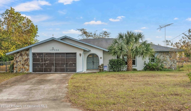 single story home featuring french doors, a garage, and a front lawn