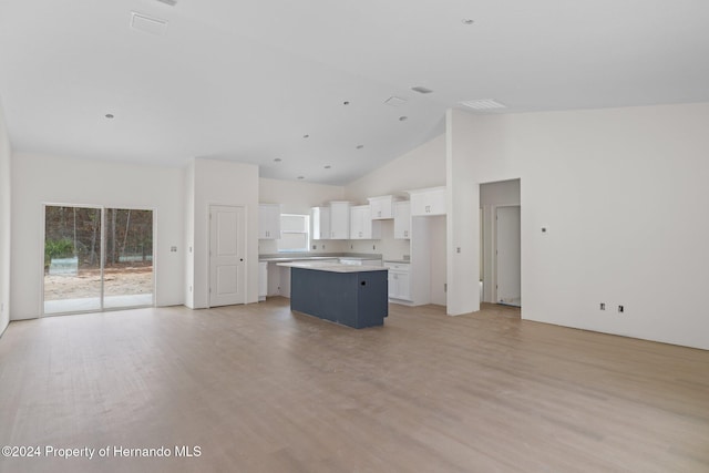 unfurnished living room featuring light hardwood / wood-style flooring and high vaulted ceiling