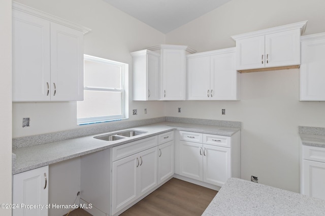 kitchen with hardwood / wood-style flooring, white cabinetry, and sink