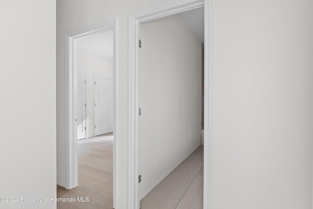 hallway with light hardwood / wood-style floors