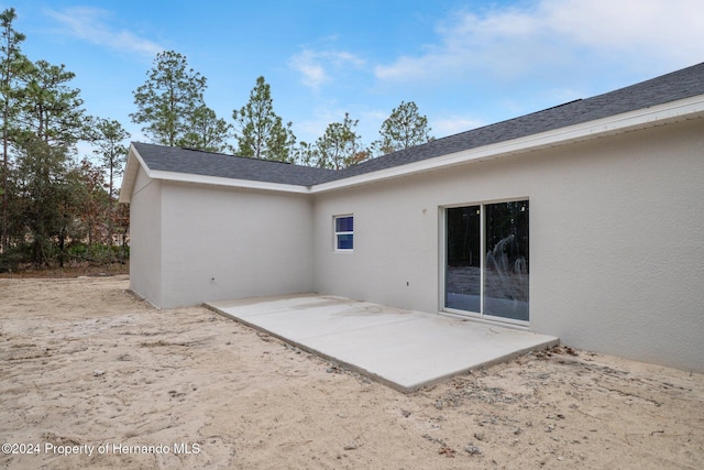 rear view of property featuring a patio area