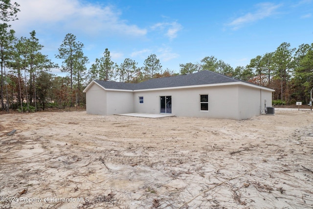 rear view of house with a patio area and central AC