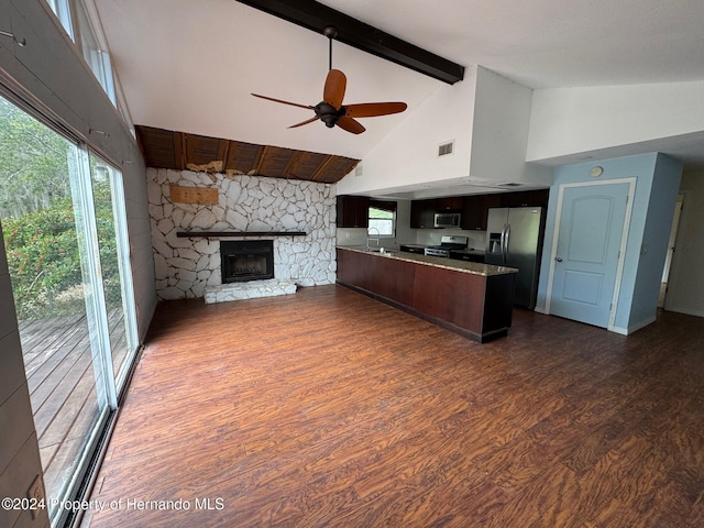 kitchen with high vaulted ceiling, plenty of natural light, dark hardwood / wood-style floors, and appliances with stainless steel finishes