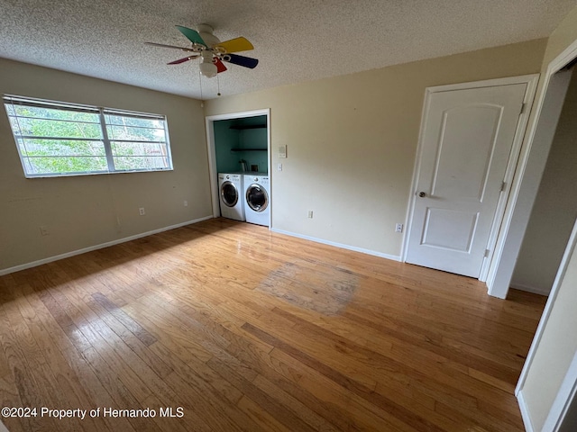 washroom featuring ceiling fan, light hardwood / wood-style floors, separate washer and dryer, and a textured ceiling