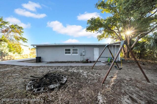 rear view of house with a playground