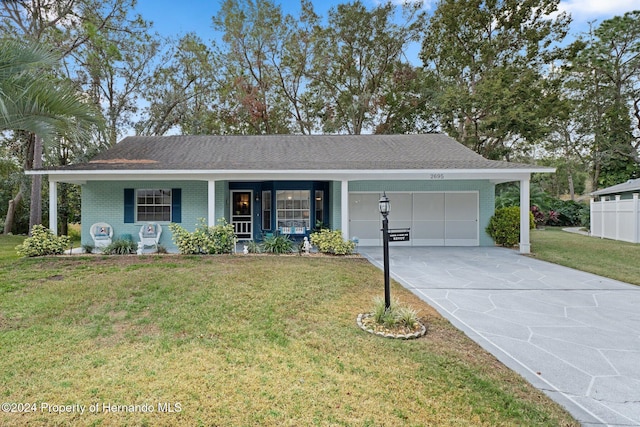 ranch-style home with a porch, a garage, and a front lawn