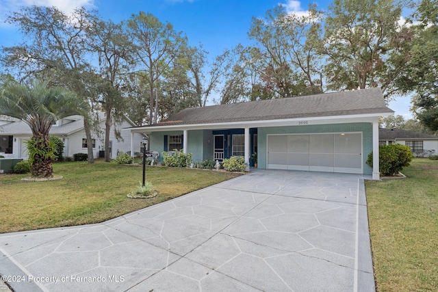 single story home with a front yard and a garage