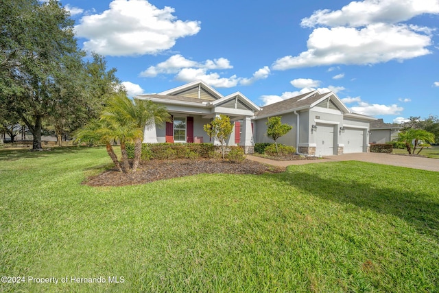 view of front of home with a garage and a front yard