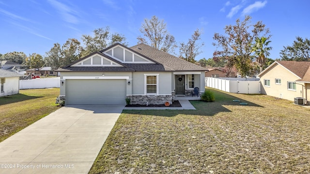 view of front of home with central air condition unit, a front yard, and a garage